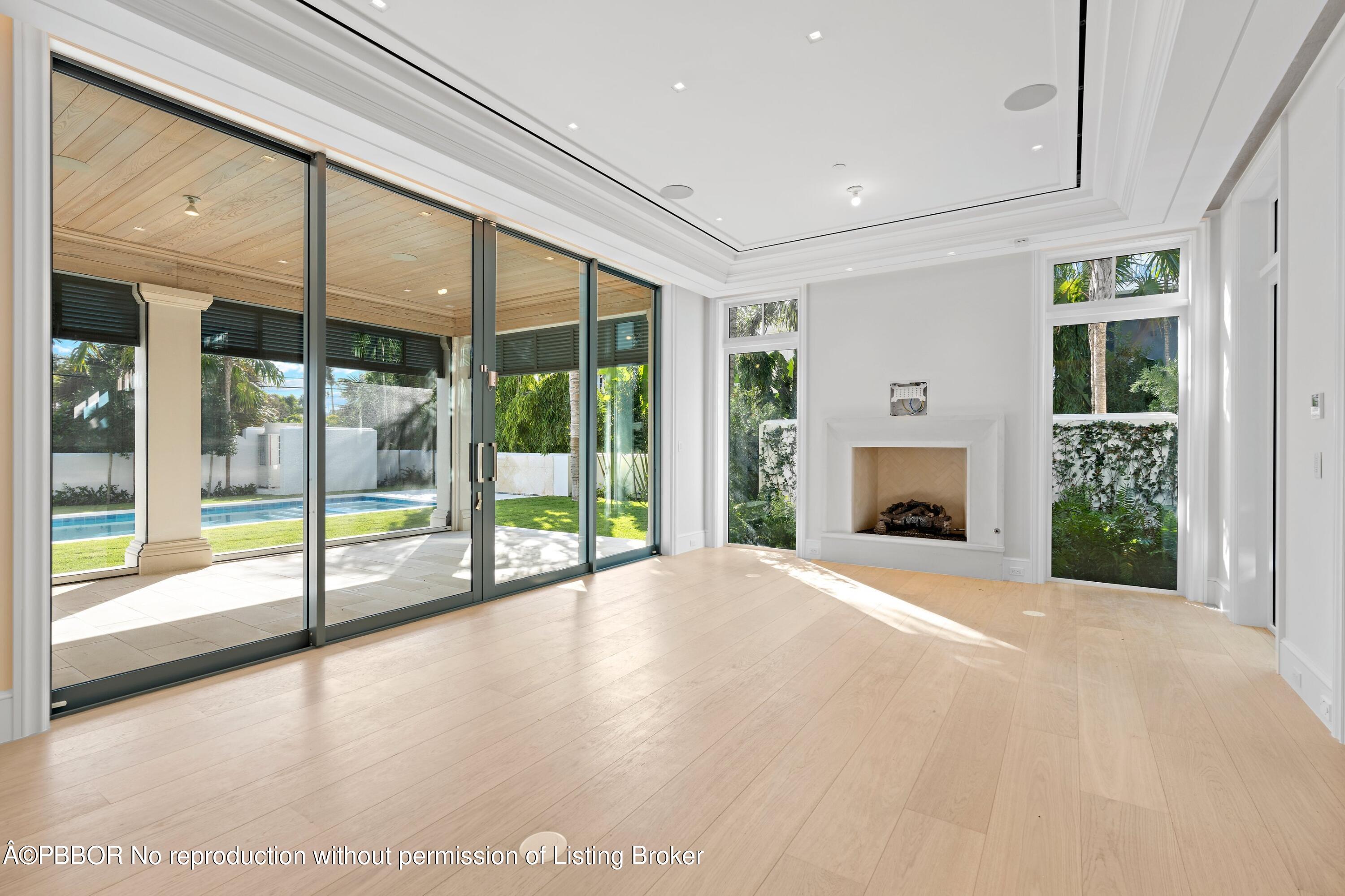 Undisclosed Address Palm Beach, FL 33480 - Photo 14 of 27 a view of an empty room with a fireplace and a window