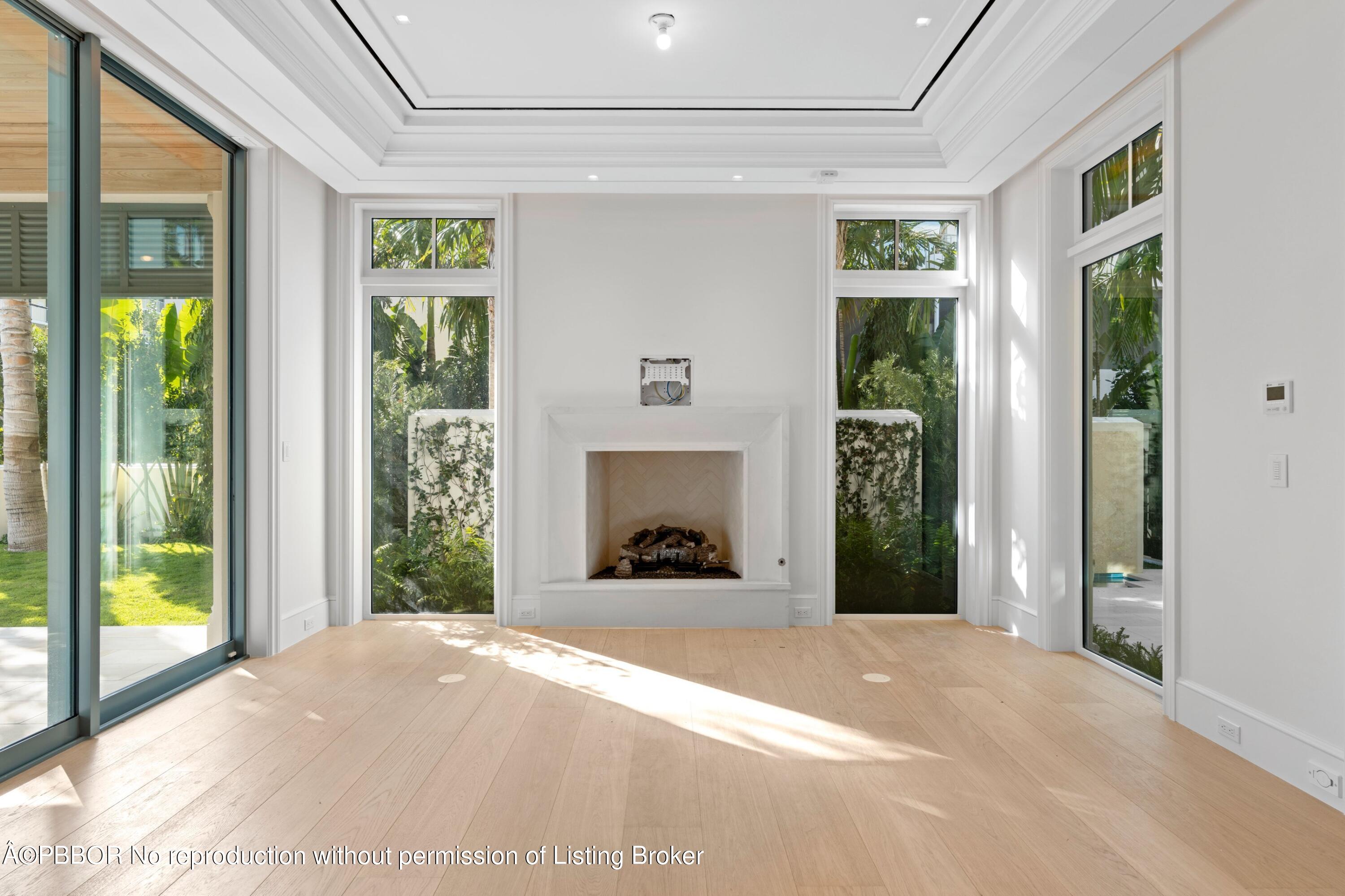 Undisclosed Address Palm Beach, FL 33480 - Photo 15 of 27 a view of a livingroom with a fireplace and windows