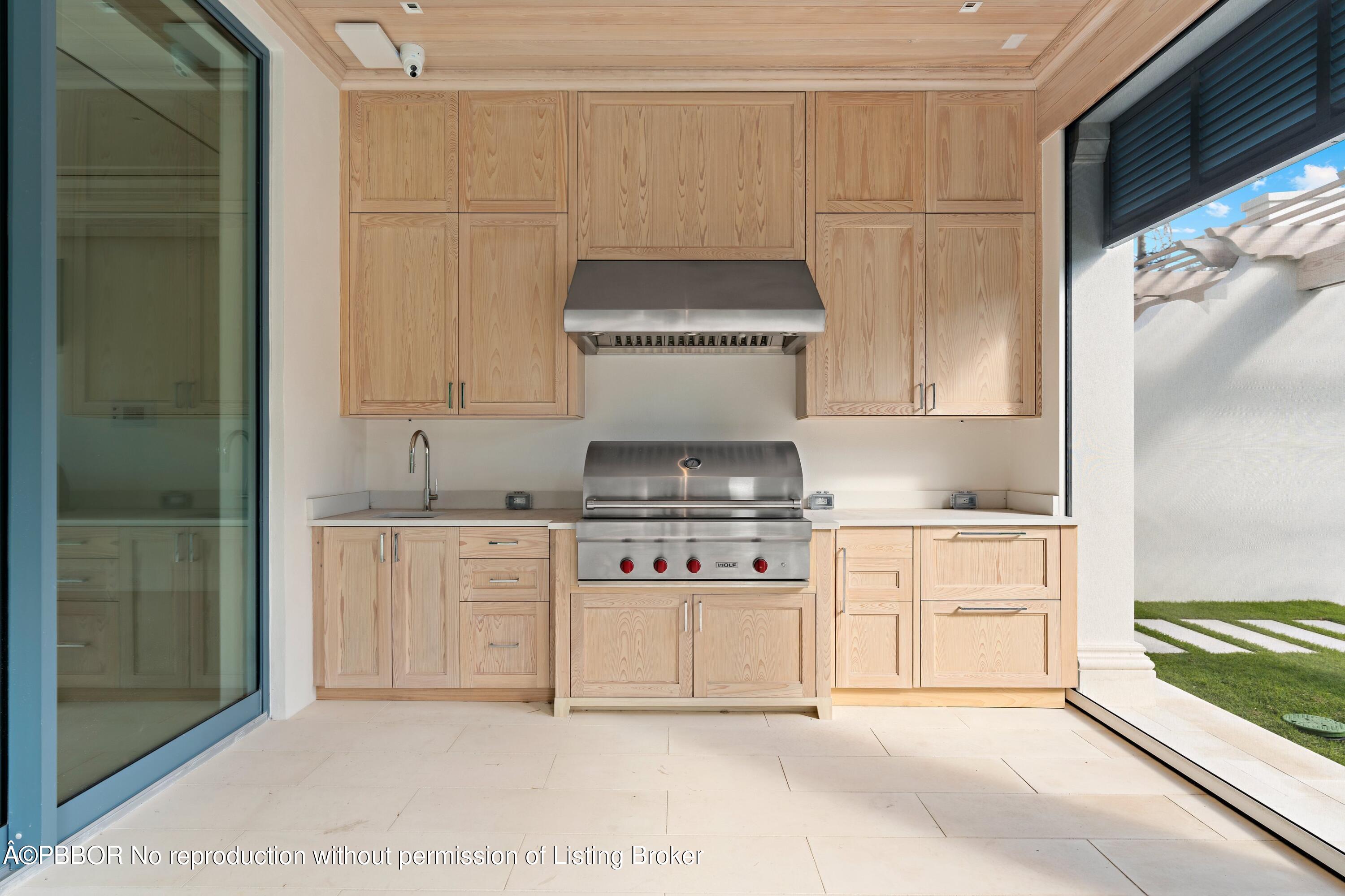 Undisclosed Address Palm Beach, FL 33480 - Photo 21 of 27 a kitchen with a stove and white cabinets