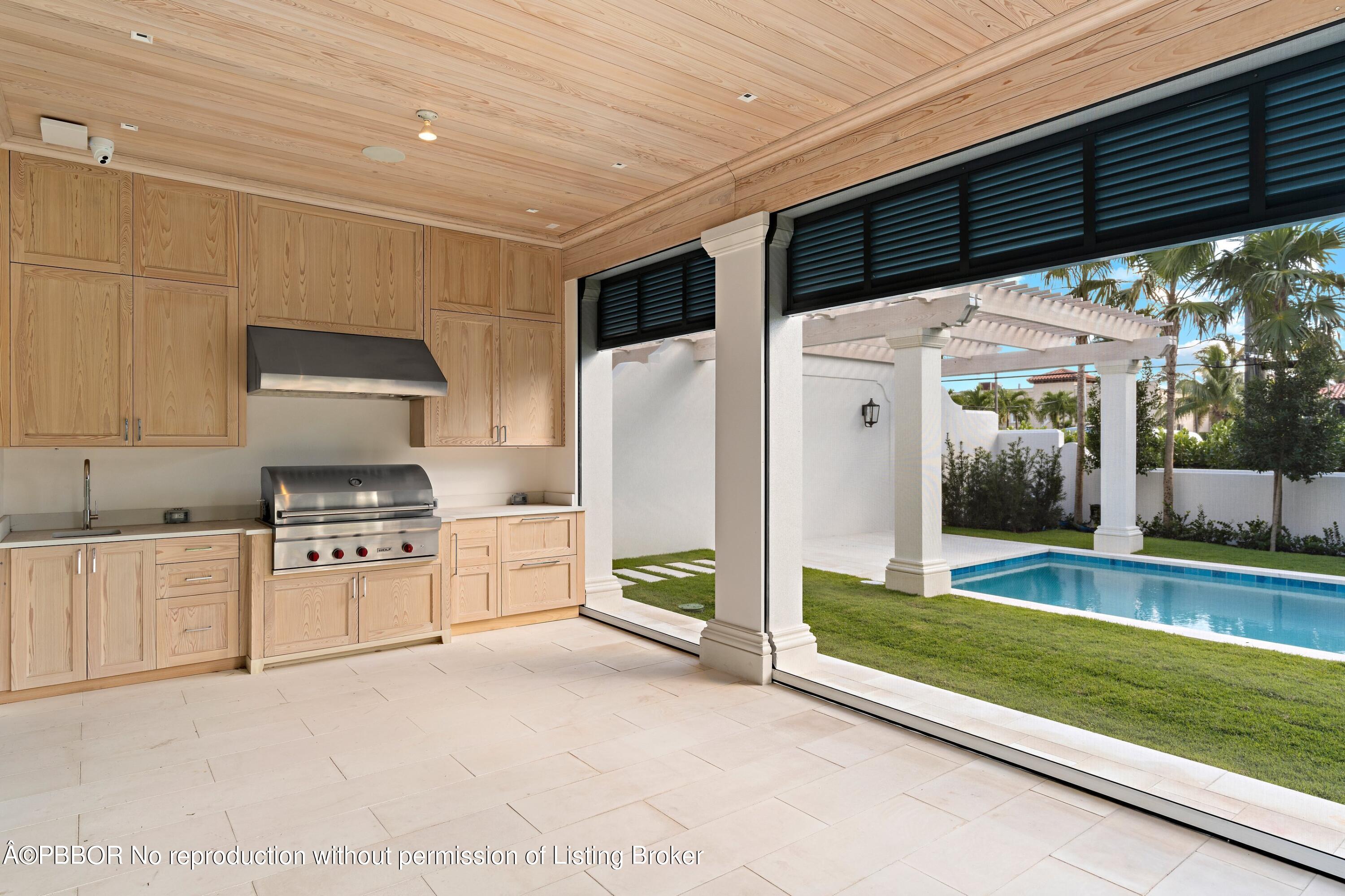 Undisclosed Address Palm Beach, FL 33480 - Photo 22 of 27 a kitchen with stainless steel appliances granite countertop a refrigerator and a stove