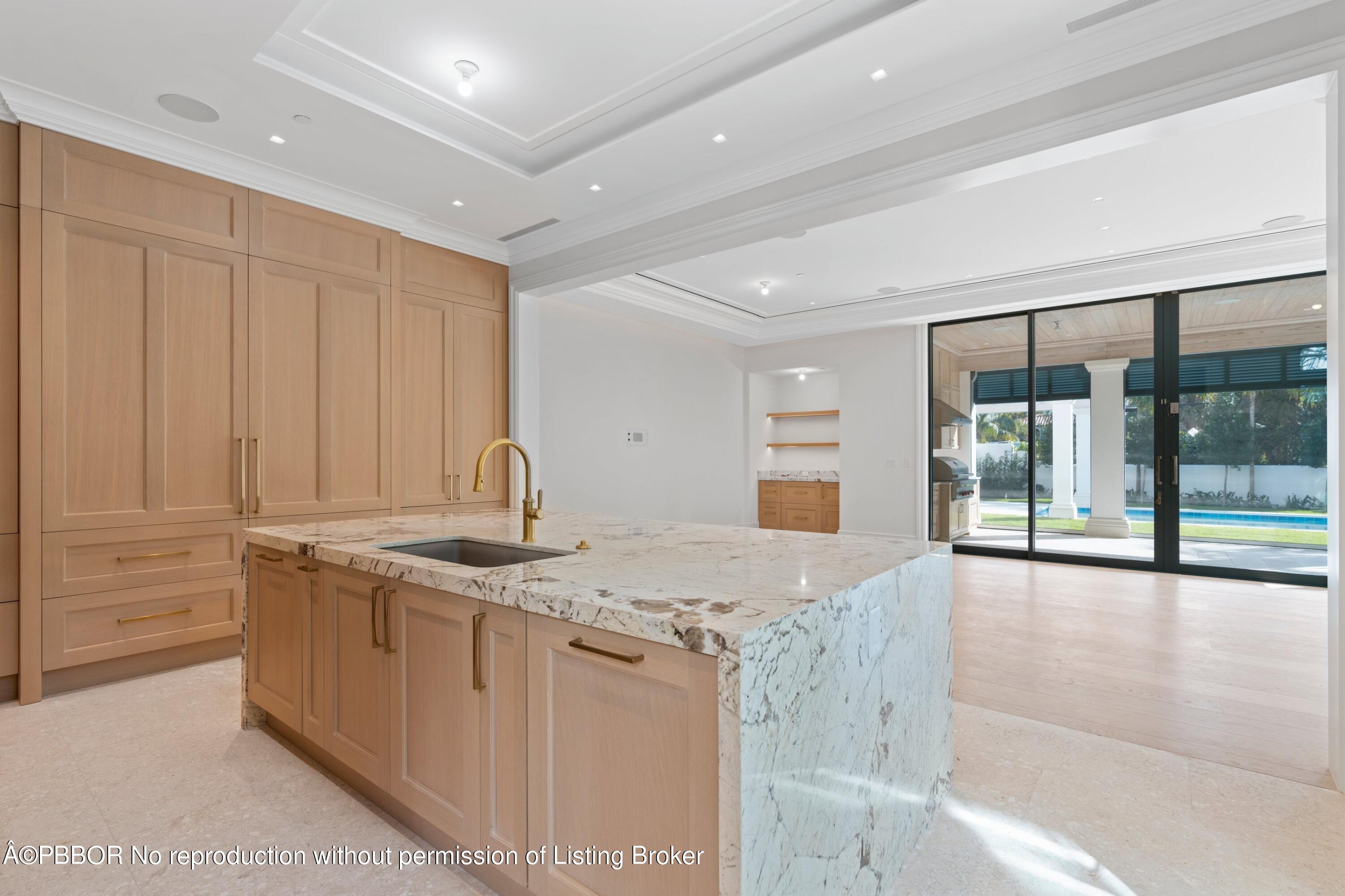 Undisclosed Address Palm Beach, FL 33480 - Photo 8 of 27 a hall with kitchen island granite countertop a sink and a large window