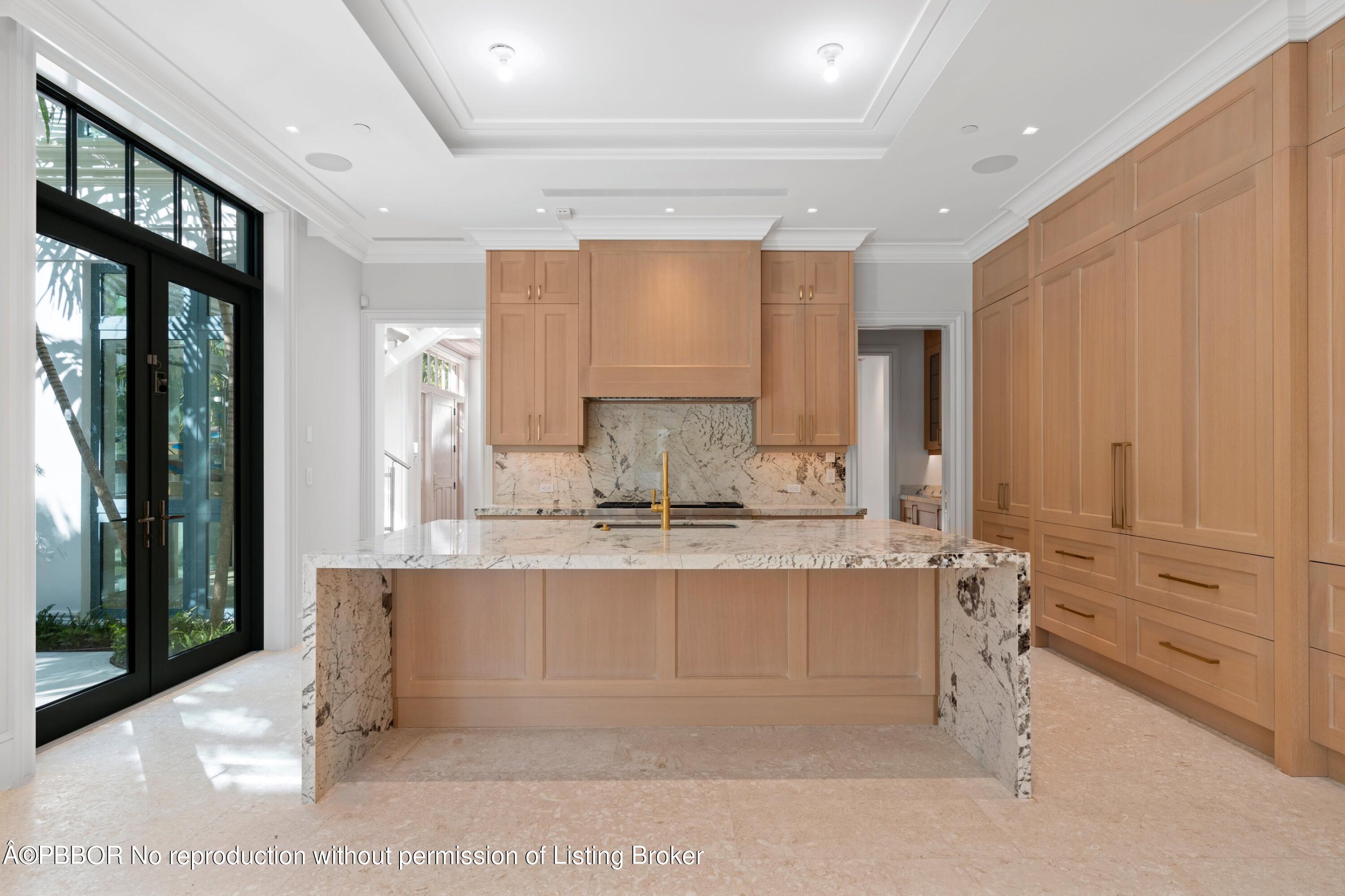 Undisclosed Address Palm Beach, FL 33480 - Photo 9 of 27 a view of a kitchen with kitchen island a sink a counter top space and cabinets