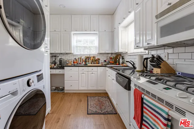 a kitchen with a stove oven and a sink