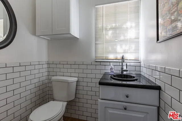 a bathroom with a toilet a sink and a window