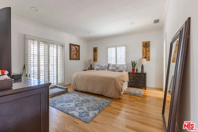 a bedroom with a large bed and a window