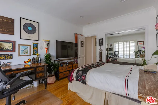 a bedroom with a bed and a flat screen tv