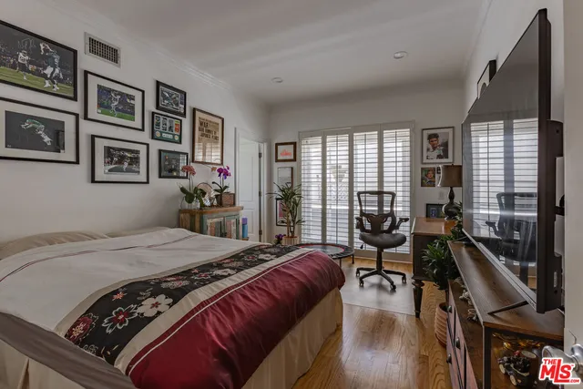 a bed sitting in a bedroom next to a window