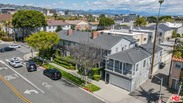 an aerial view of multiple houses with a yard