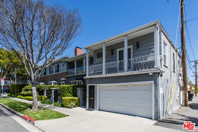 a front view of a building with garden