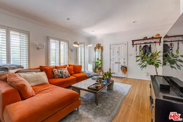 a living room with furniture lamp and window