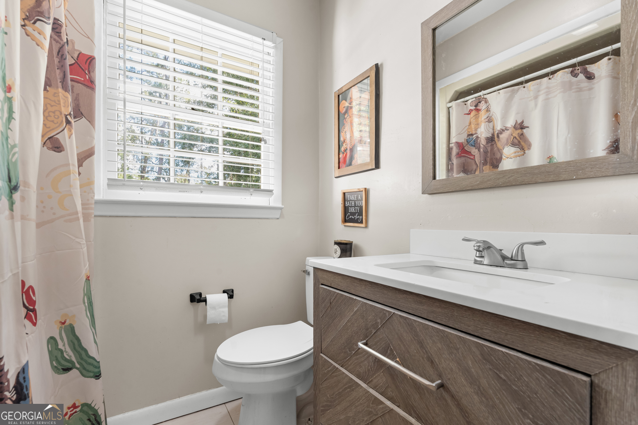 313 Gentilly Road Statesboro, GA 30458 - Photo 20 of 25 a bathroom with a sink a toilet and a window