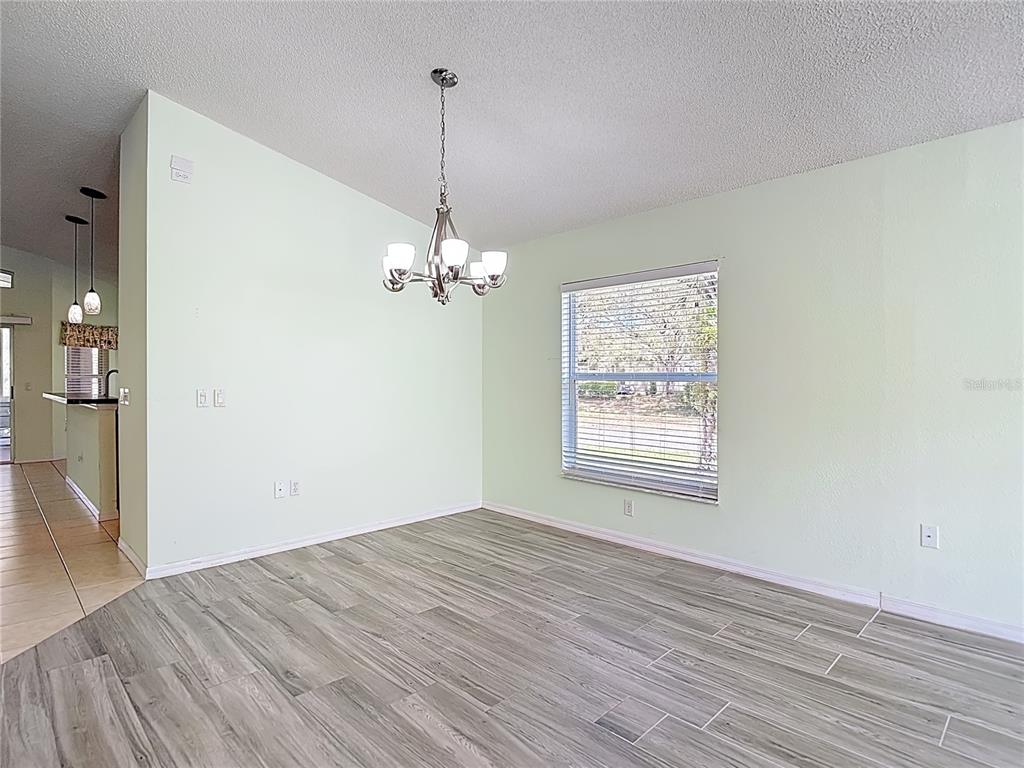 280 Quane Avenue Spring Hill, FL 34609 - Photo 12 of 62 a view of an empty room with wooden floor and a window