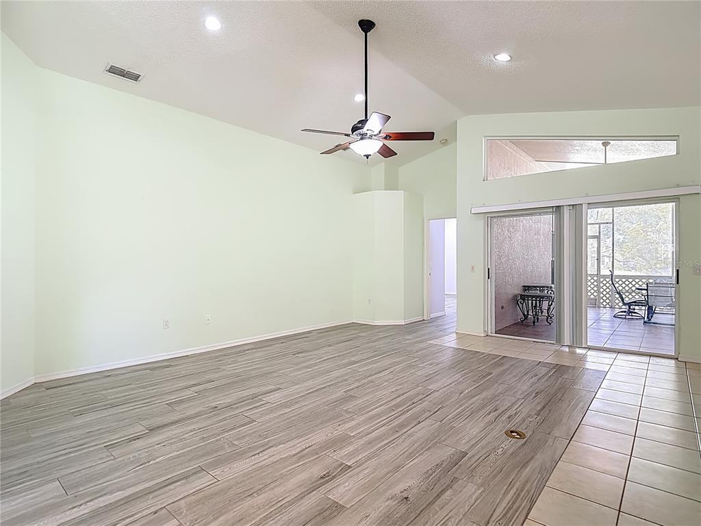 280 Quane Avenue Spring Hill, FL 34609 - Photo 14 of 62 a view of an empty room with window and wooden floor