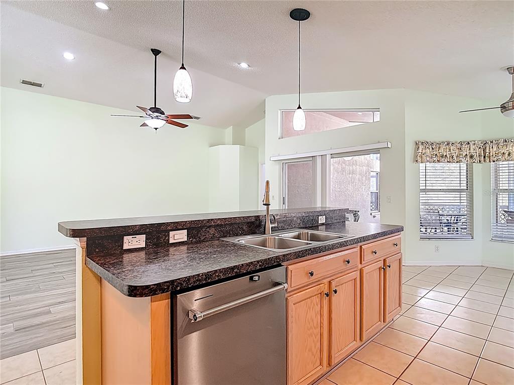 280 Quane Avenue Spring Hill, FL 34609 - Photo 17 of 62 a kitchen with stainless steel appliances granite countertop a sink a counter space and a window