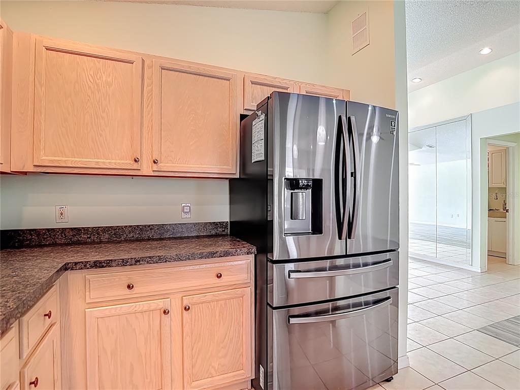 280 Quane Avenue Spring Hill, FL 34609 - Photo 18 of 62 a kitchen with metallic refrigerator and cabinets