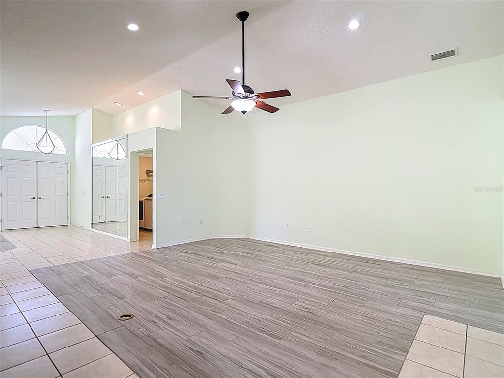 280 Quane Avenue Spring Hill, FL 34609 - Photo 23 of 62 a view of a livingroom with a ceiling fan a ceiling fan and hardwood floor