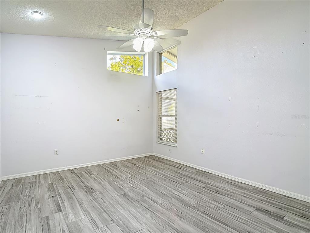 280 Quane Avenue Spring Hill, FL 34609 - Photo 25 of 62 a view of empty room with windows and ceiling fan