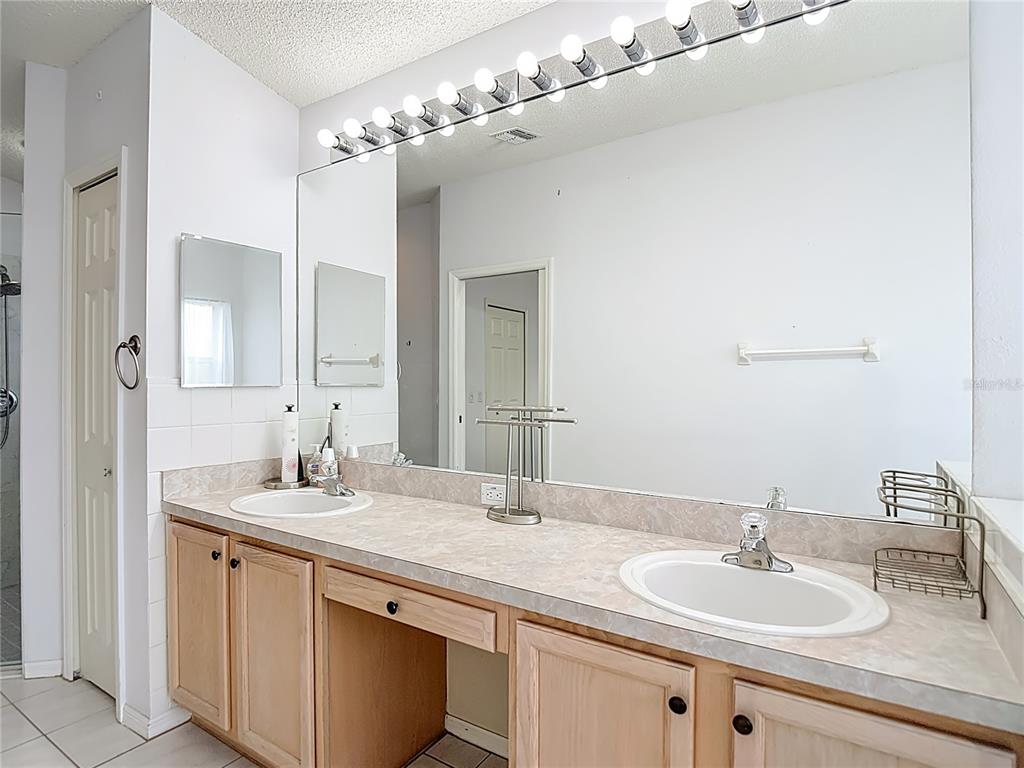 280 Quane Avenue Spring Hill, FL 34609 - Photo 31 of 62 a bathroom with a double vanity sink and a mirror