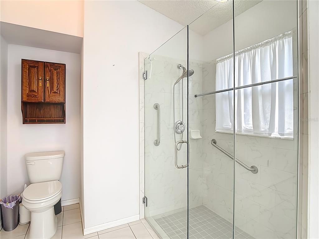 280 Quane Avenue Spring Hill, FL 34609 - Photo 32 of 62 a bathroom with a toilet sink and shower