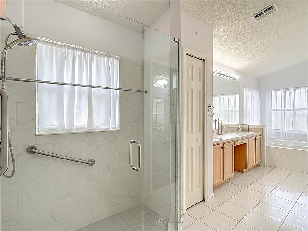 280 Quane Avenue Spring Hill, FL 34609 - Photo 33 of 62 a bathroom with a granite countertop sink a toilet and shower