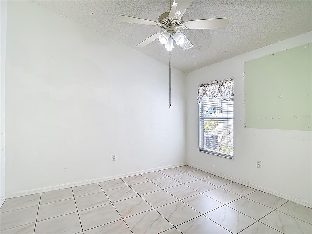280 Quane Avenue Spring Hill, FL 34609 - Photo 34 of 62 an empty room with windows and fan