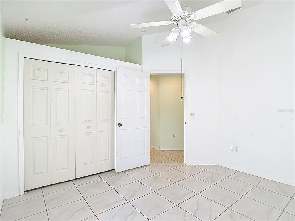 280 Quane Avenue Spring Hill, FL 34609 - Photo 36 of 62 an empty room with fan and entryway
