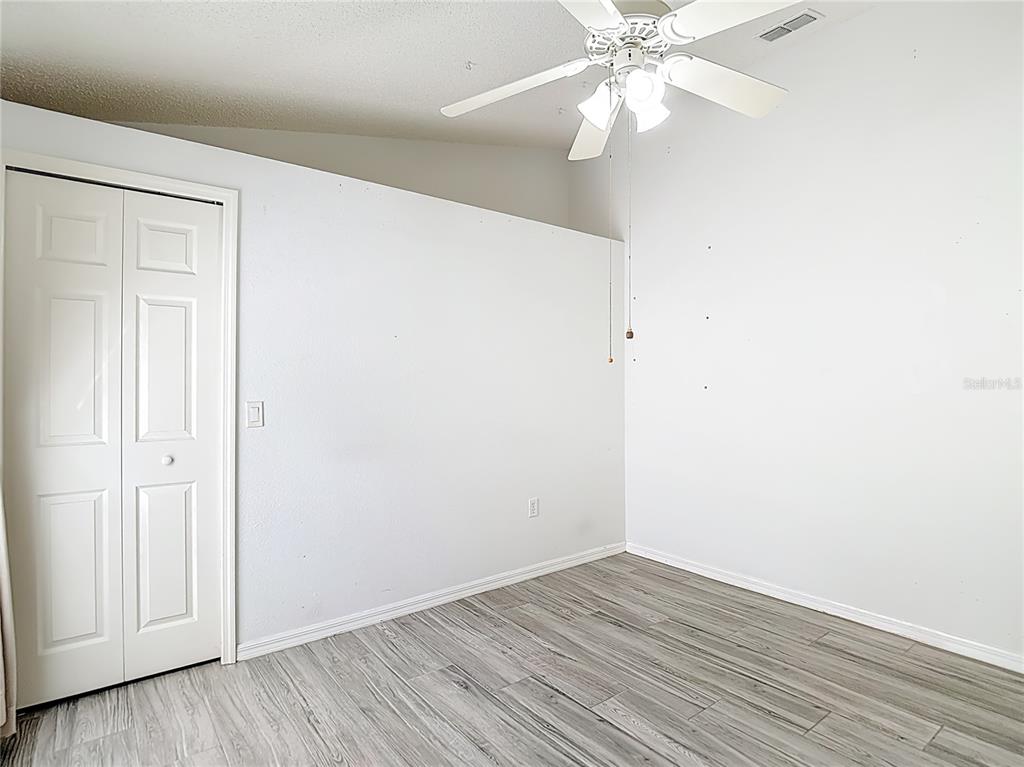 280 Quane Avenue Spring Hill, FL 34609 - Photo 38 of 62 a view of an empty room with wooden floor