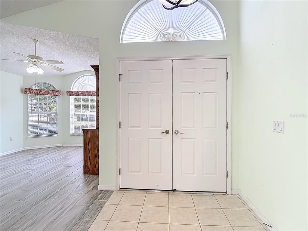 280 Quane Avenue Spring Hill, FL 34609 - Photo 6 of 62 wooden floor in an empty room with a window