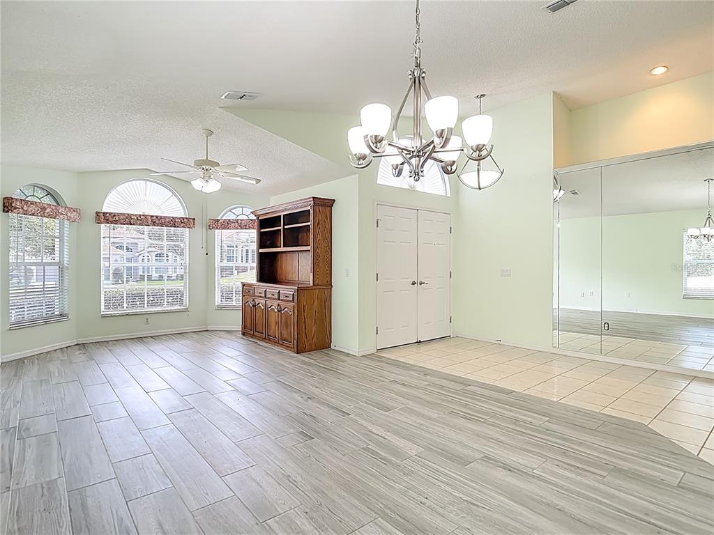 280 Quane Avenue Spring Hill, FL 34609 - Photo 9 of 62 a view of a room with wooden floor and chandelier
