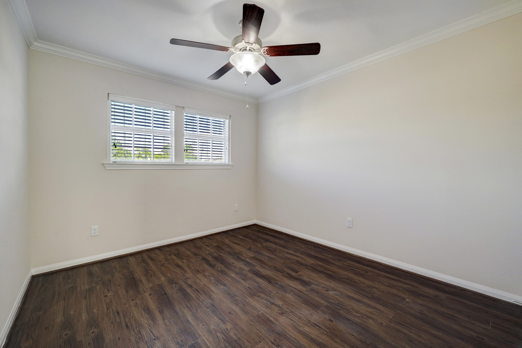 214 West 17th Street, Unit 2 Houston, TX 77008 - Photo 3 of 8 a view of an empty room with a window and wooden floor