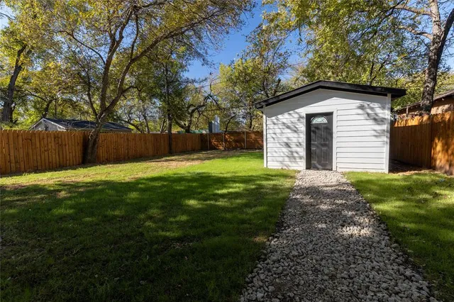 a view of a backyard with a large tree