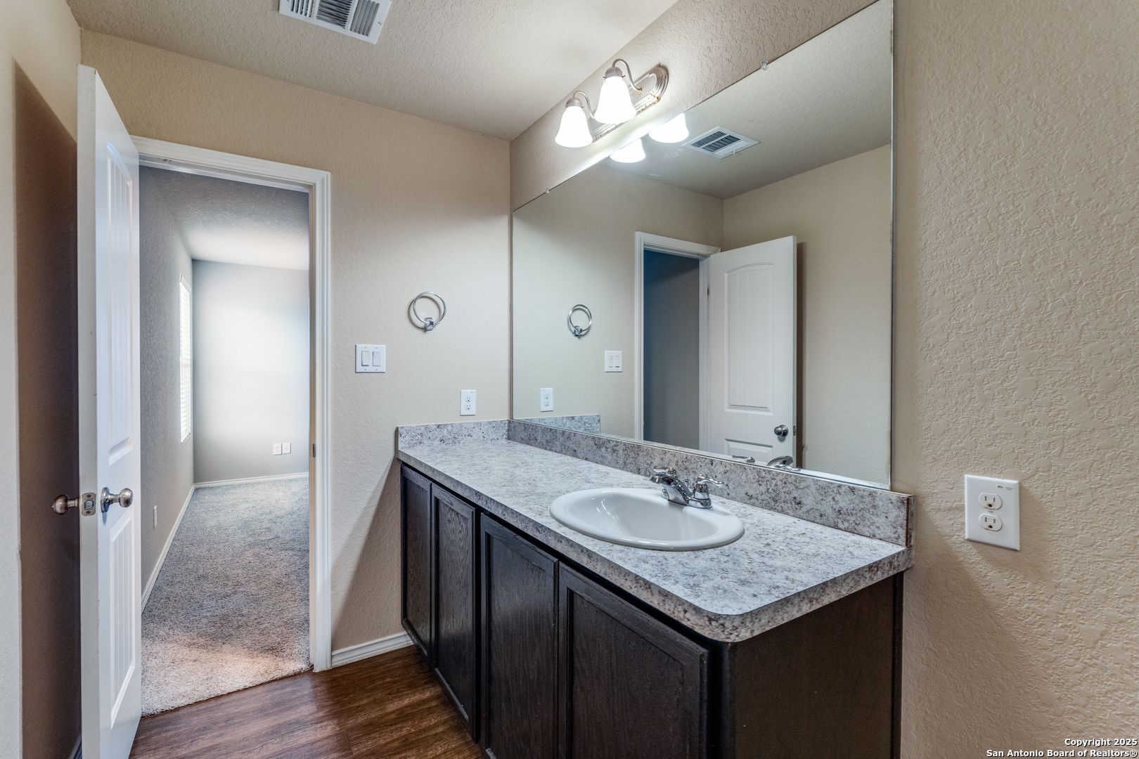 5102 Everett Loop Converse, TX 78109 - Photo 16 of 24 a bathroom with a granite countertop sink a vanity and a mirror