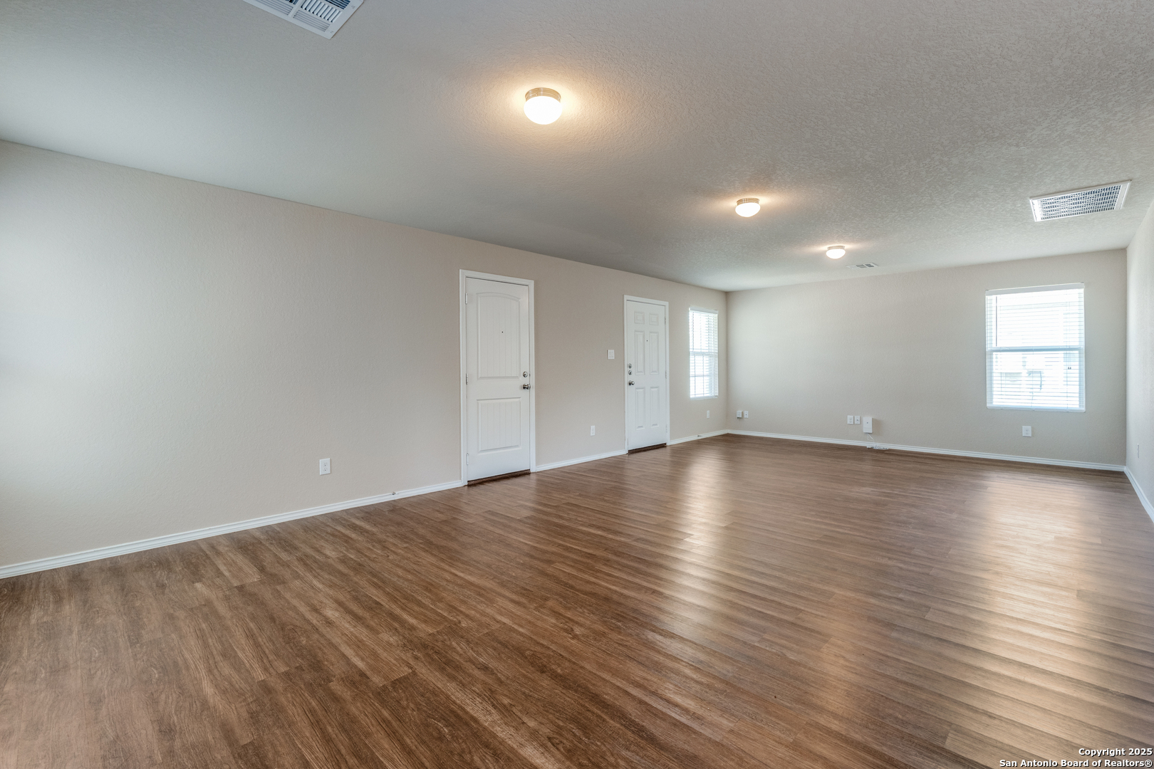 5102 Everett Loop Converse, TX 78109 - Photo 5 of 24 an empty room with wooden floor and windows