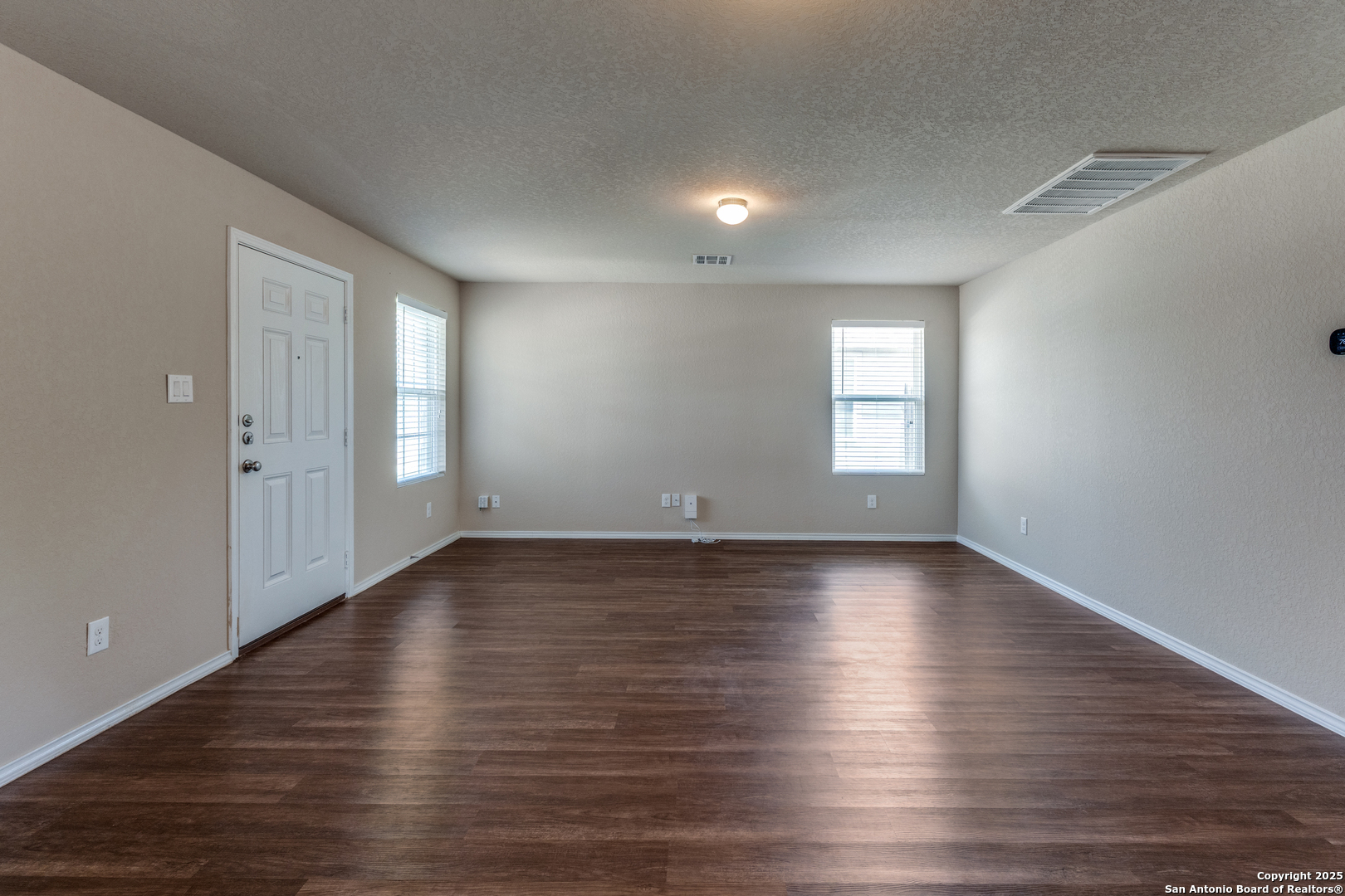 5102 Everett Loop Converse, TX 78109 - Photo 6 of 24 an empty room with wooden floor and windows