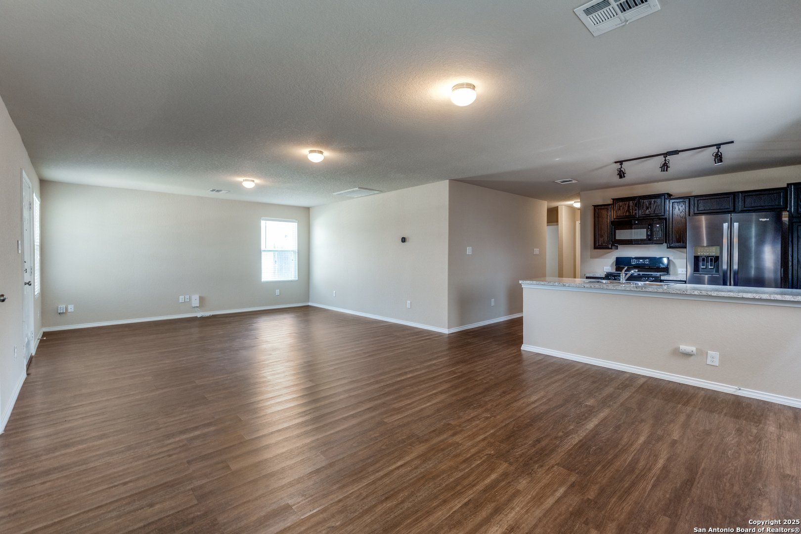 5102 Everett Loop Converse, TX 78109 - Photo 8 of 24 a view of empty room with kitchen and window