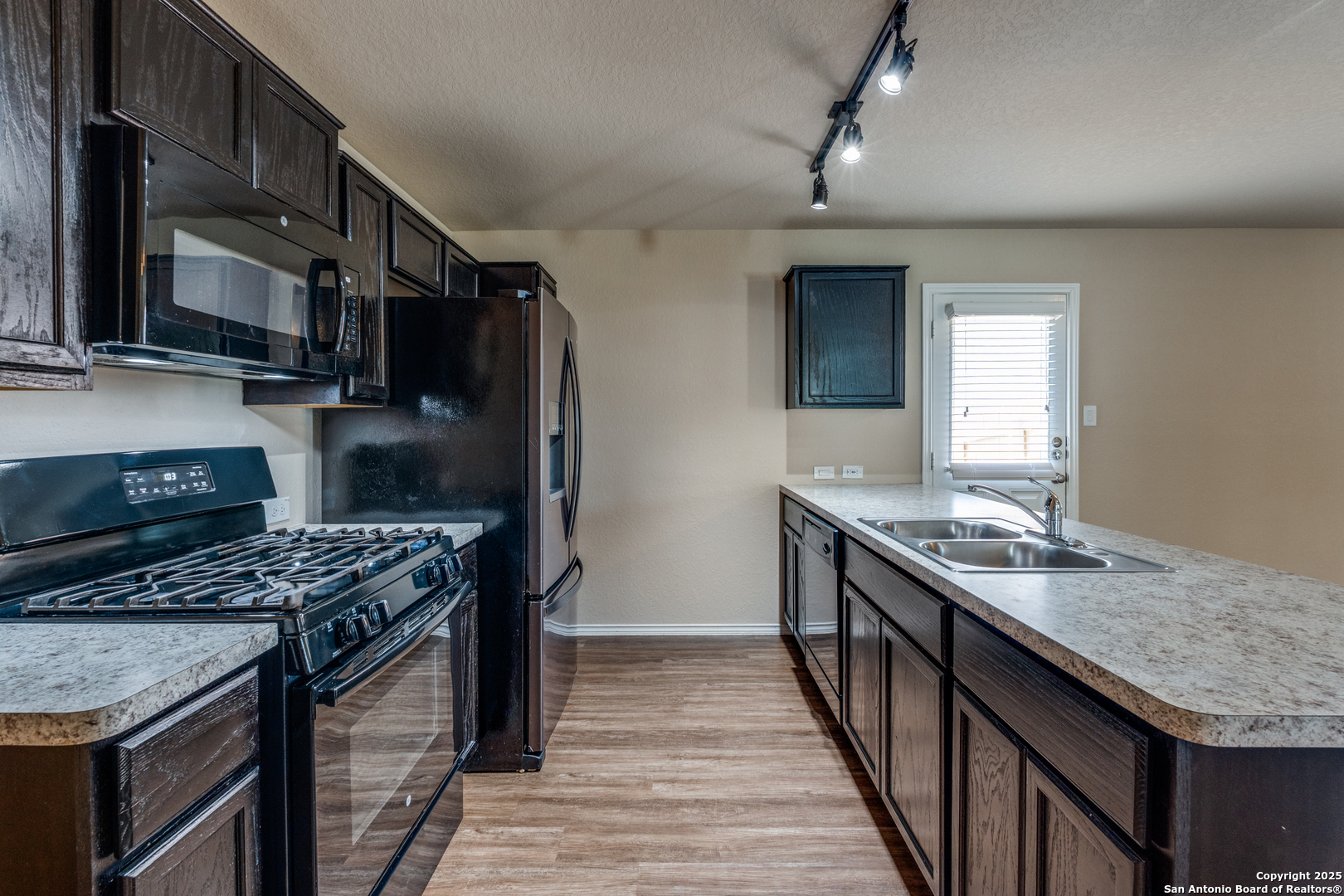 5102 Everett Loop Converse, TX 78109 - Photo 9 of 24 a kitchen with granite countertop a sink a stove and refrigerator