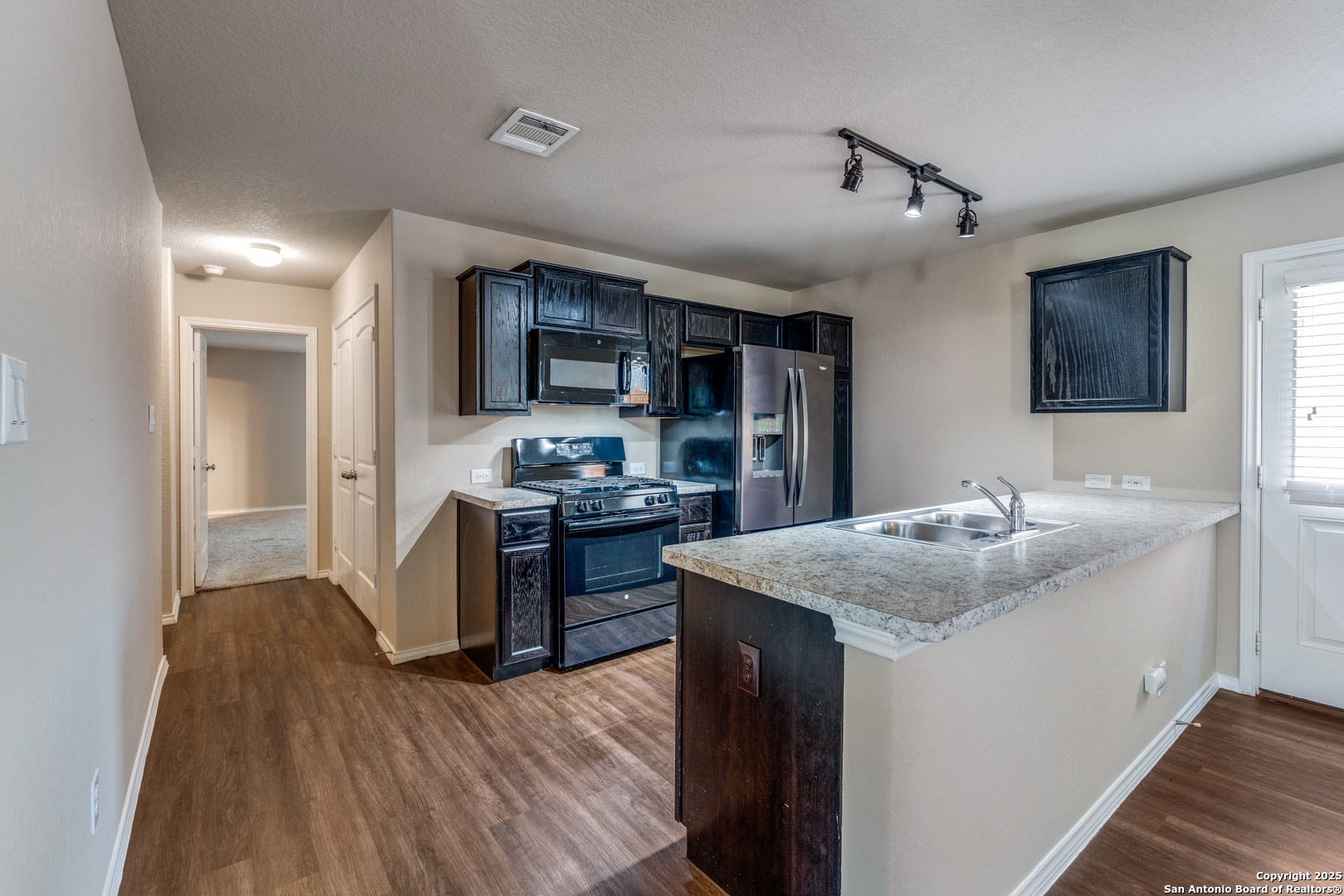 5102 Everett Loop Converse, TX 78109 - Photo 10 of 24 a kitchen with kitchen island stainless steel appliances a sink stove and refrigerator