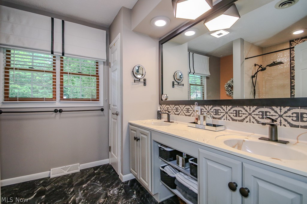 1966 Spring Grove Madison, OH 44057 - Photo 29 of 50 Double Bowl Vanities highlighed by the full length mirror offers both spouses equal access when it's crunch time for getting ready.