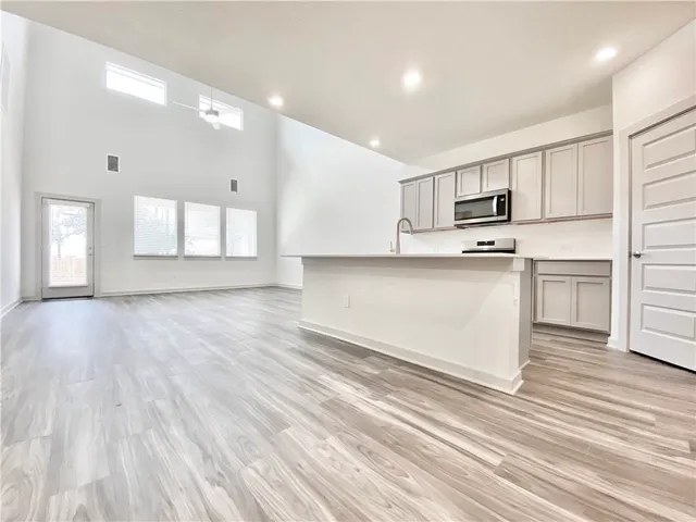 a kitchen with a sink stove and refrigerator
