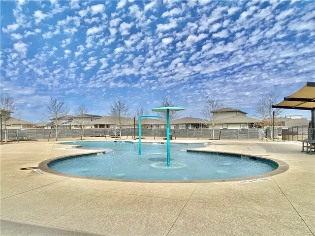 a view of a swimming pool with chairs
