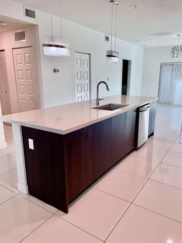 a kitchen with stainless steel appliances a sink a counter space and cabinets