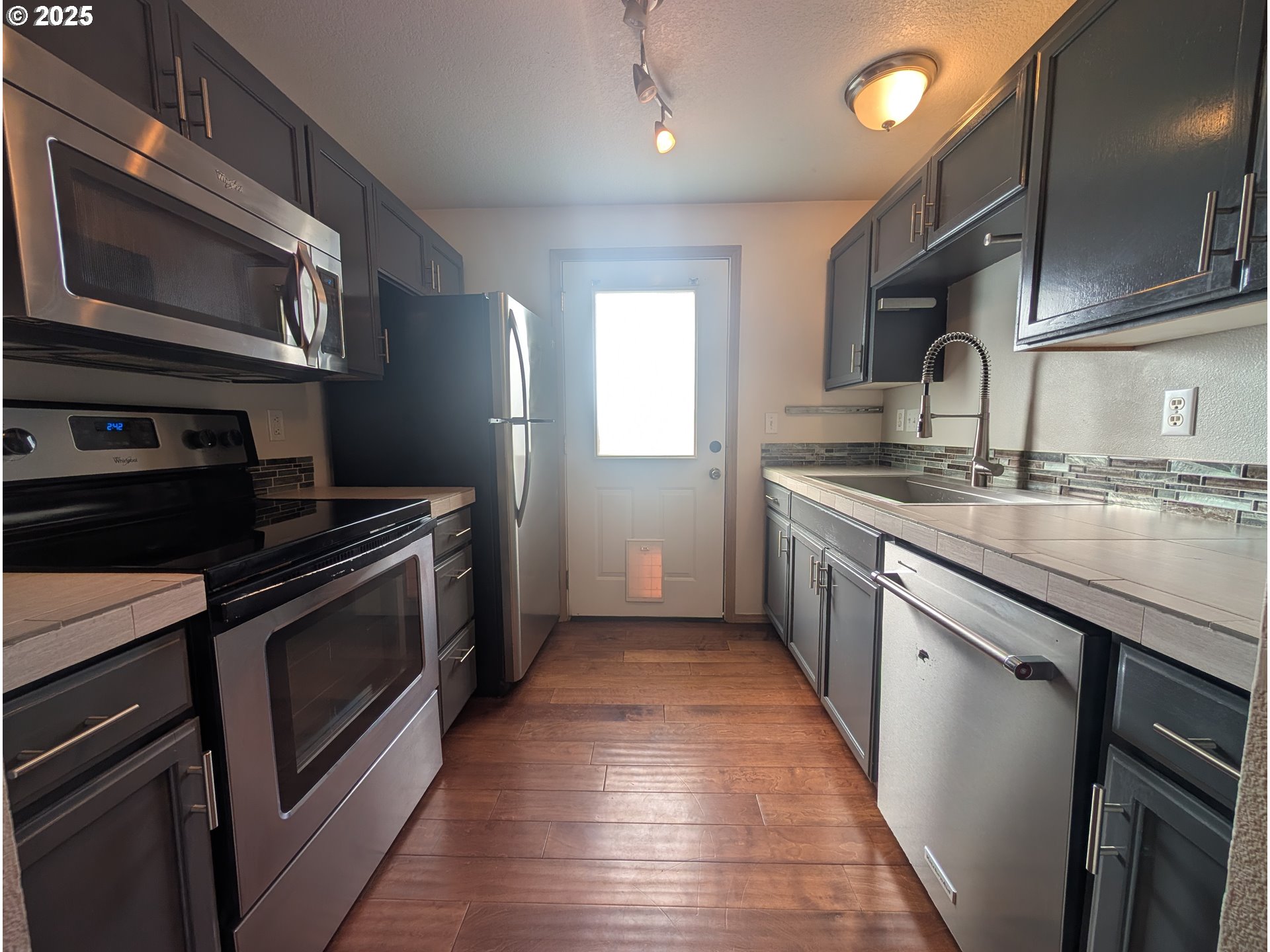 2501 East 2nd Street Newberg, OR 97132 - Photo 15 of 18 a kitchen with stainless steel appliances granite countertop a stove a sink and a microwave