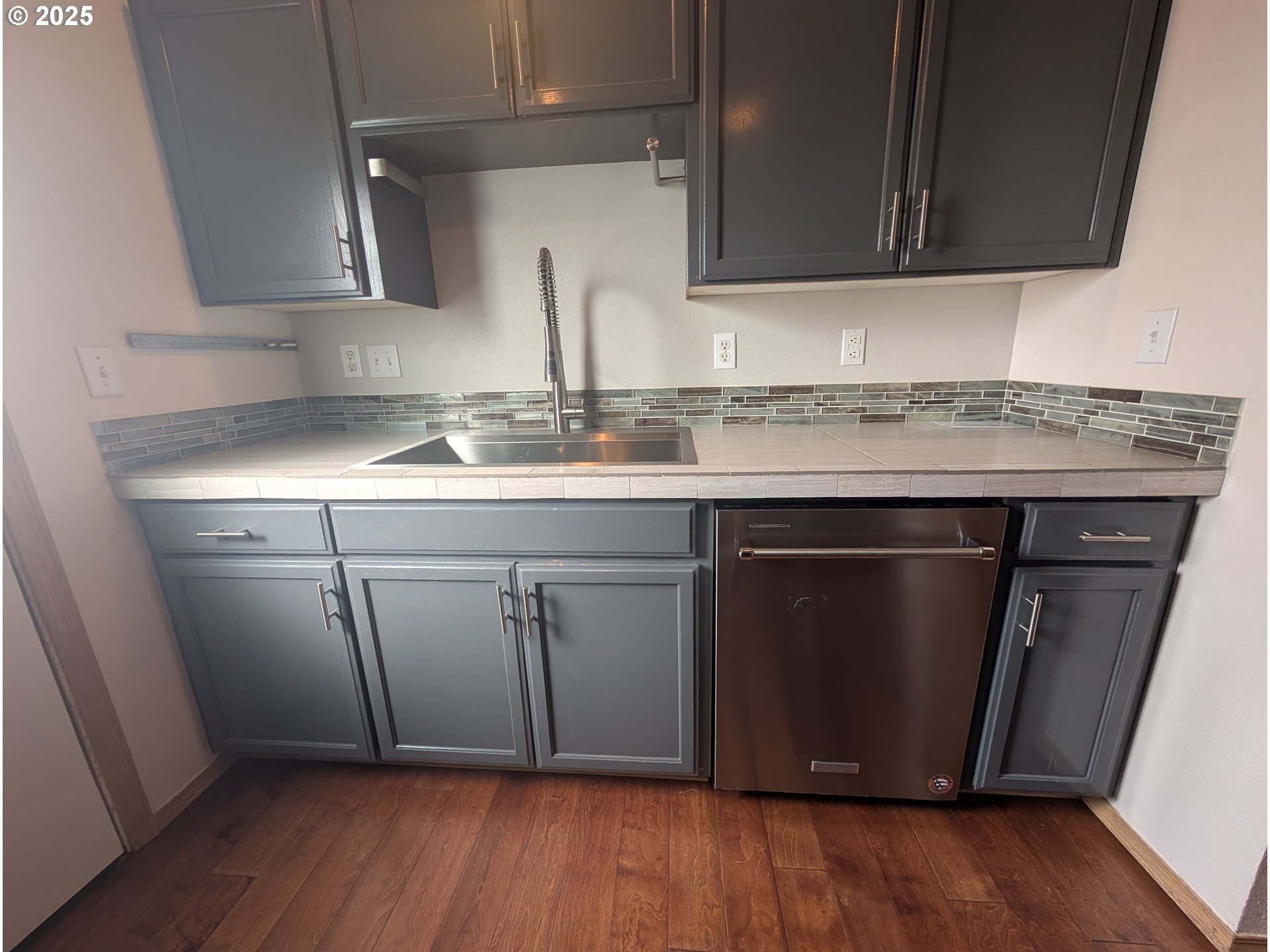 2501 East 2nd Street Newberg, OR 97132 - Photo 17 of 18 a kitchen with a sink a mirror and cabinets