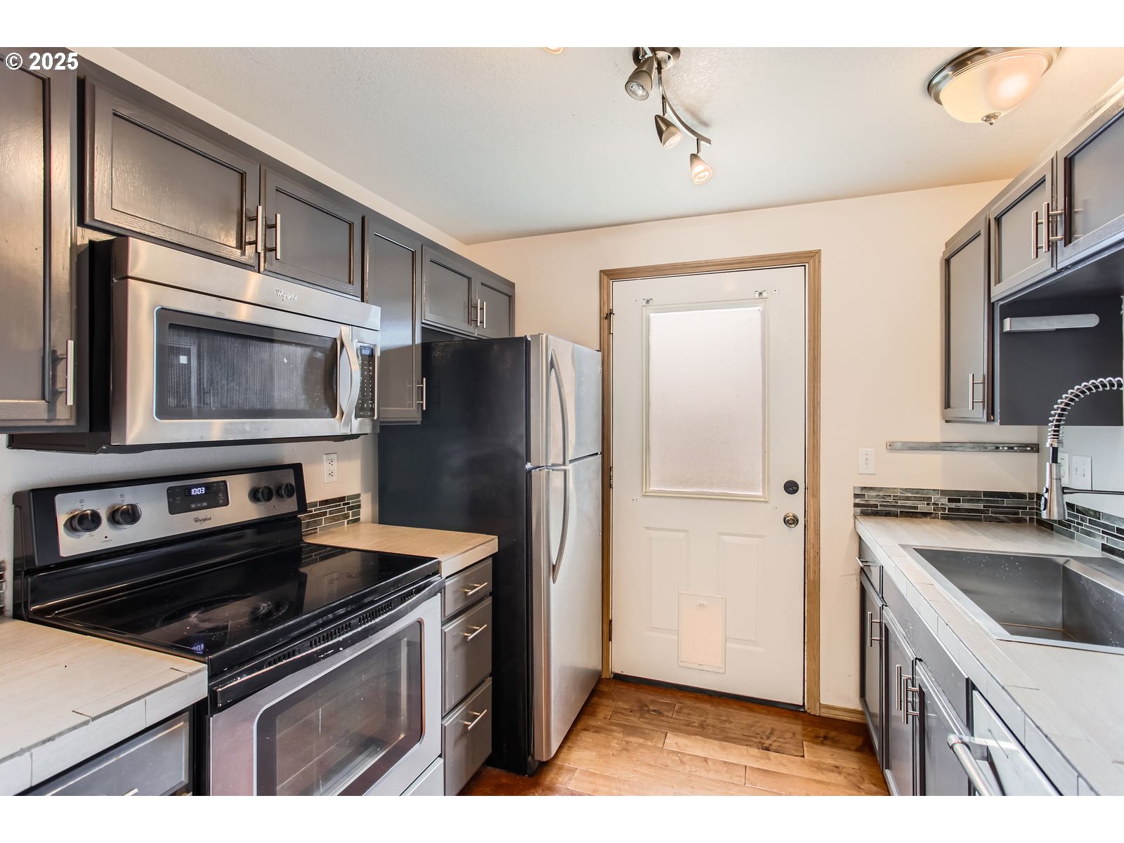 2501 East 2nd Street Newberg, OR 97132 - Photo 3 of 18 a kitchen with a refrigerator stove and sink