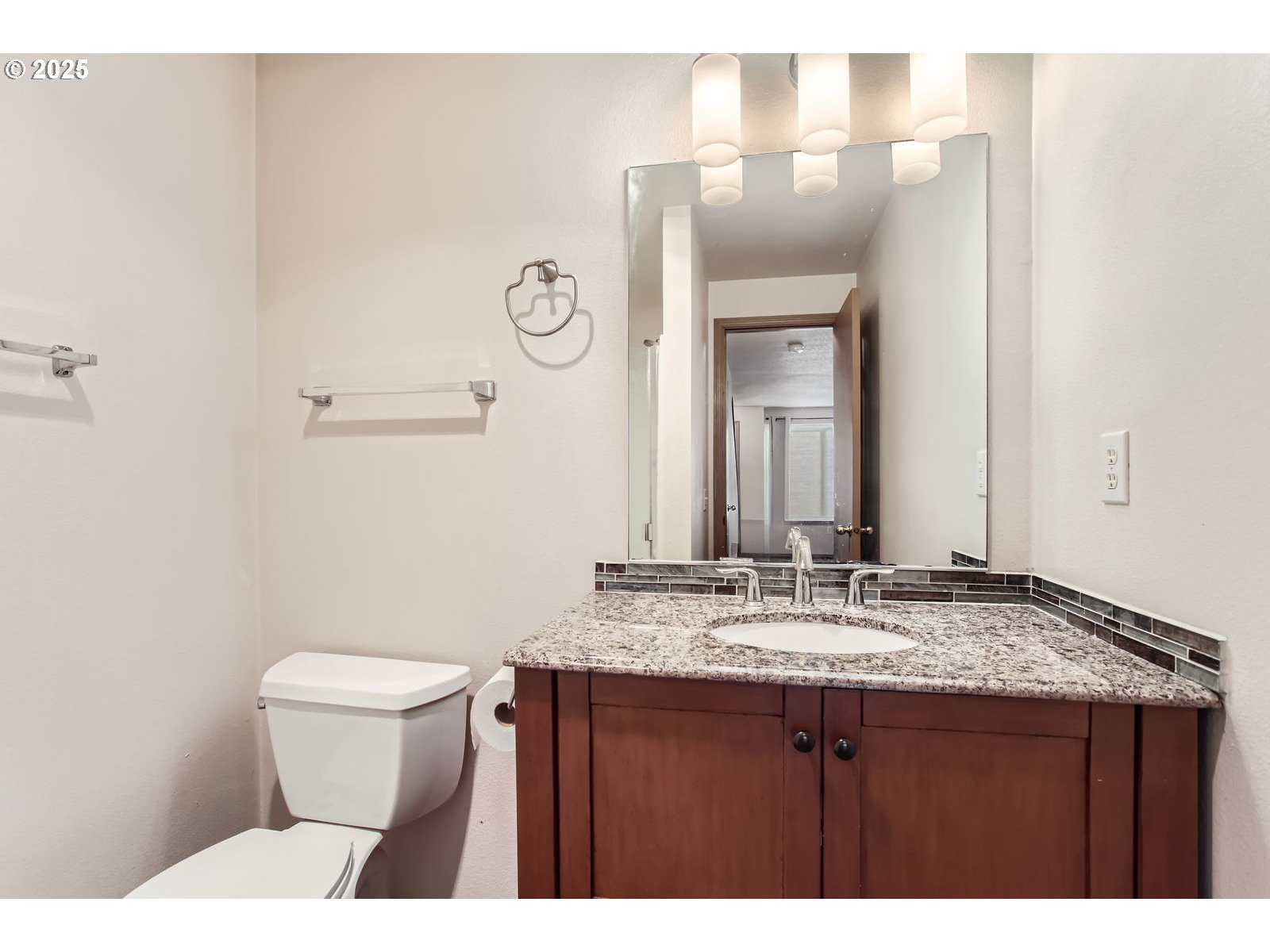 2501 East 2nd Street Newberg, OR 97132 - Photo 8 of 18 a bathroom with a granite countertop sink toilet and mirror