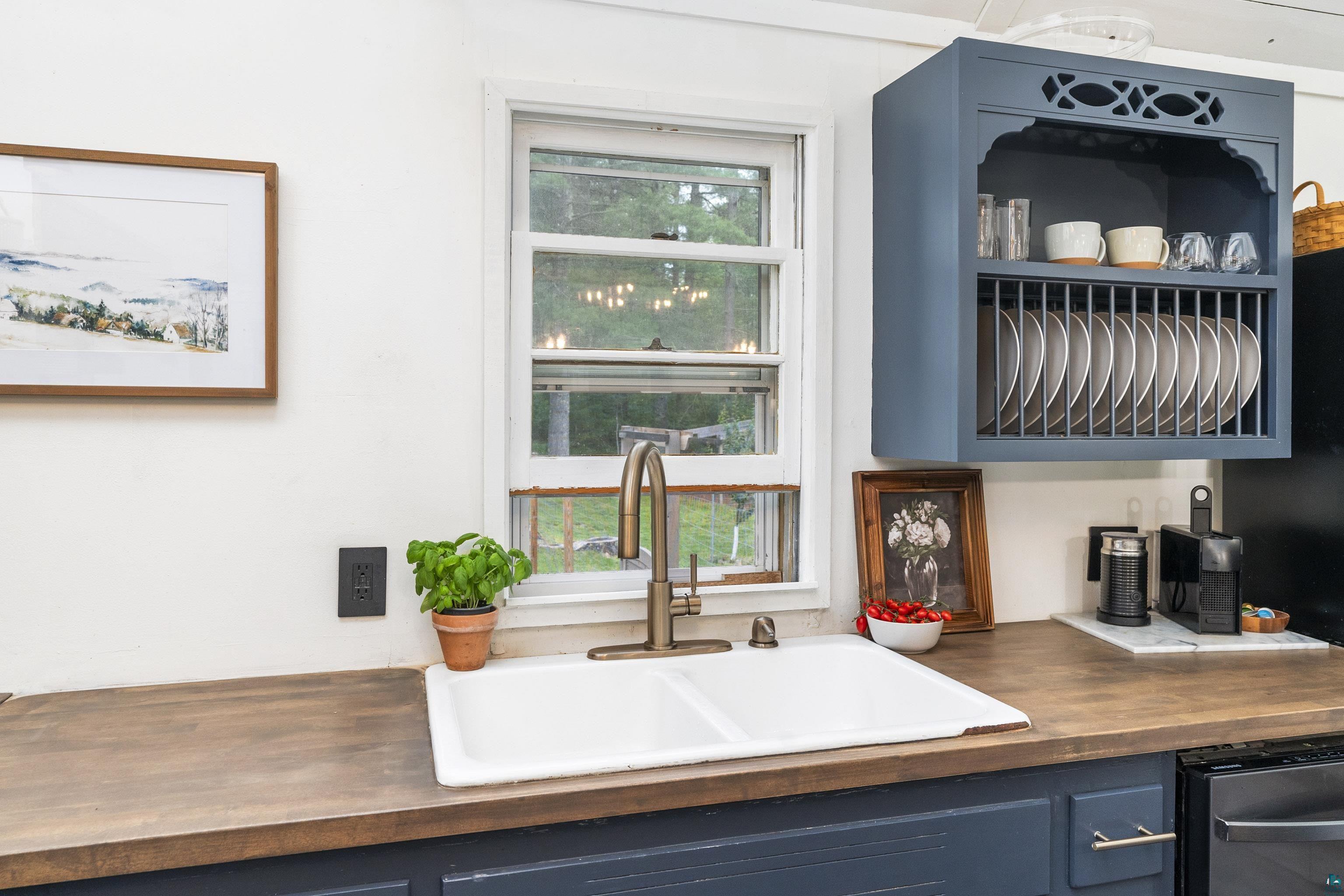 6345 Smith Lake Road Barnes, WI 54873 - Photo 21 of 50 Kitchen featuring butcher block countertops, sink, blue cabinets, and dishwashing machine