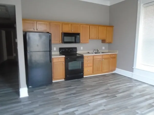 a kitchen with stainless steel appliances a refrigerator stove and microwave