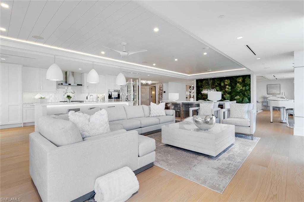 6897 Grenadier Boulevard, Unit 601 Naples, FL 34108 - Photo 6 of 48 a living room with furniture and white walls