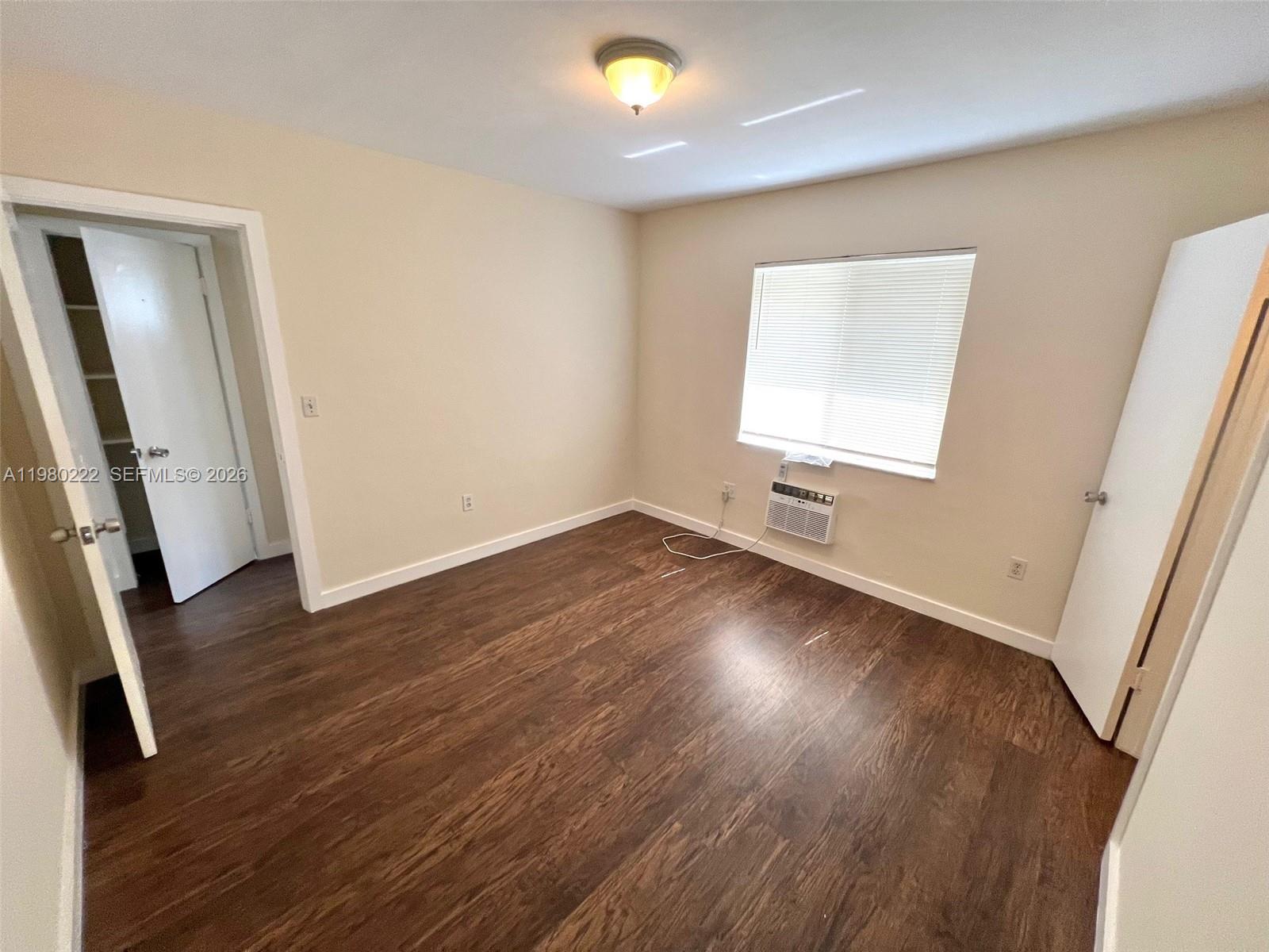692 Northeast 85th Street, Unit 6 Miami, FL 33138 - Photo 5 of 6 a view of empty room with wooden floor and fan