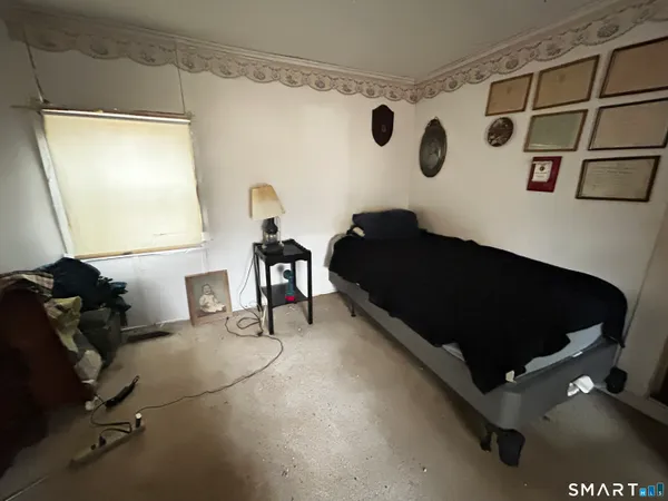 a bedroom with furniture and a window